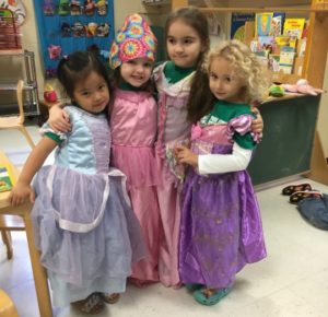 Four girls dressed up as princesses